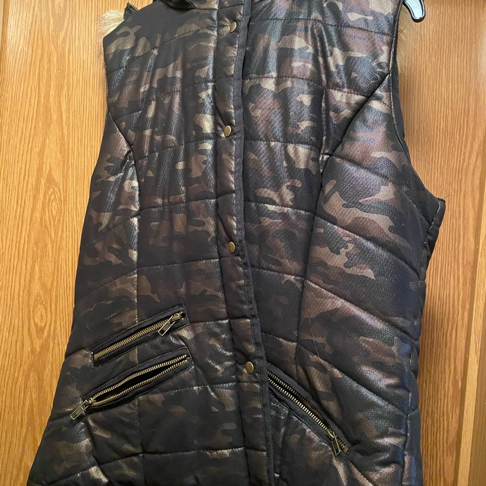 Black and gold metallic vest with a faux fur hood. Worn twice.